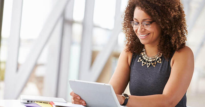 A Women working on an ipad to customize her OnPatient portal