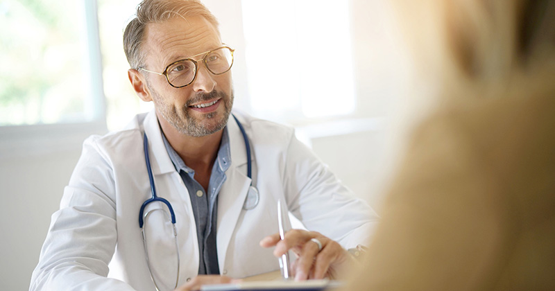 DOCTOR WITH STETHOSCOPE HOLDING PEN
