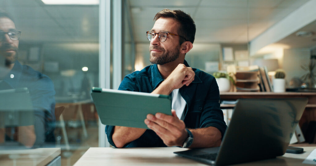 Tablet, thinking and smile with business man in office for planning, ui designer and app review. Developer solutions, reflection and research with person in agency for project idea and startup.
