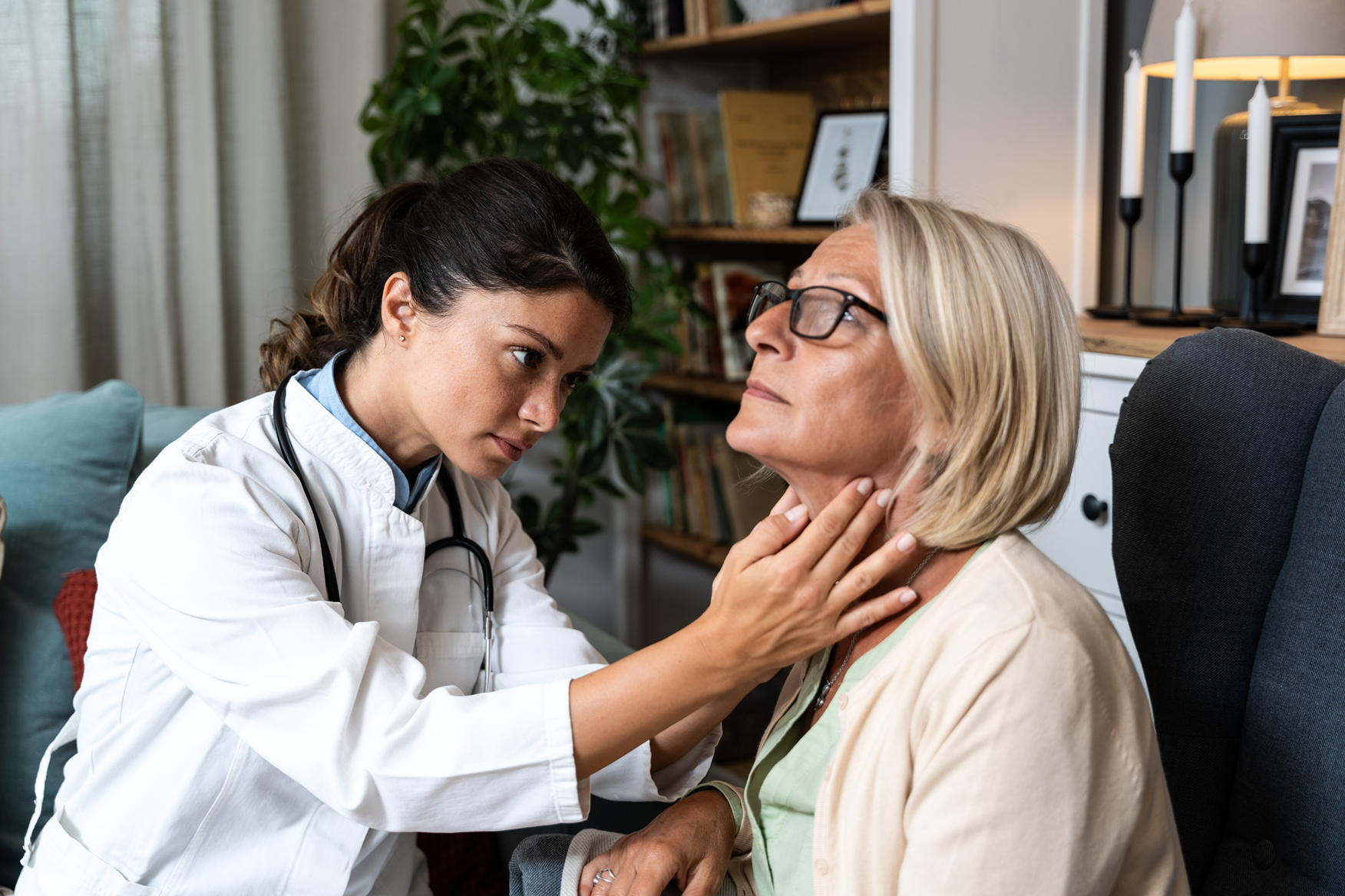 Doctor examining a patient's neck during an appointment
